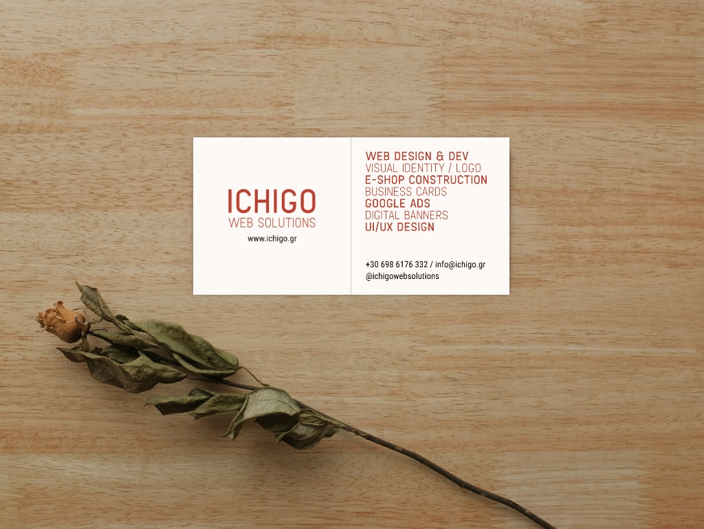Ichigo Web Solutions bifold business card on wooden surface with greenery branch