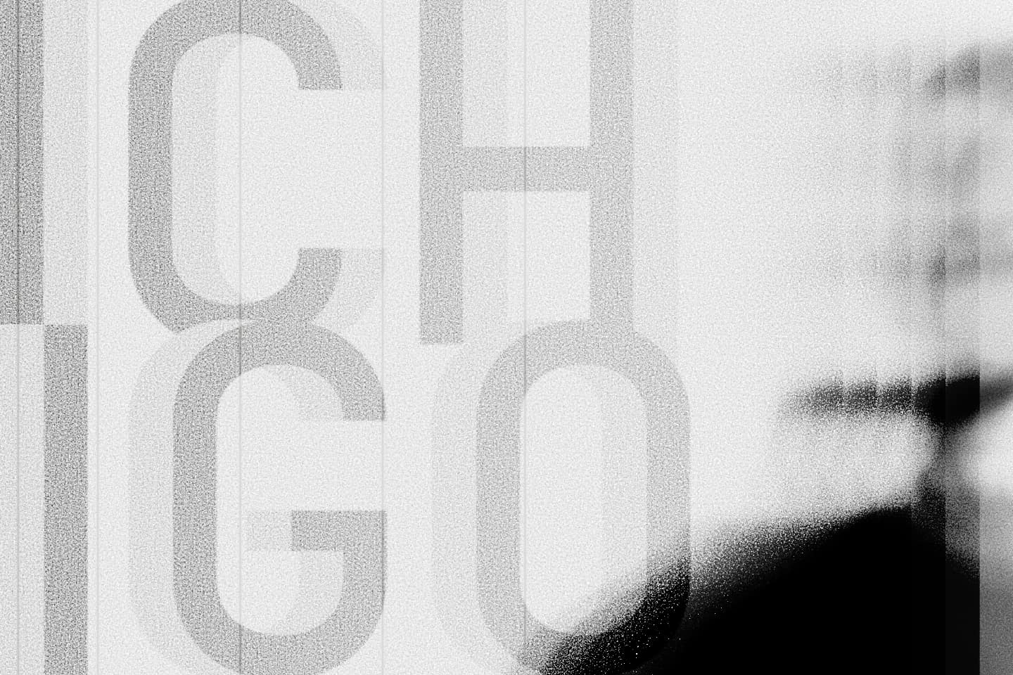 Grayscale abstract design featuring Ichigo Web Solutions logo and silhouette of Panos Pagiatis.